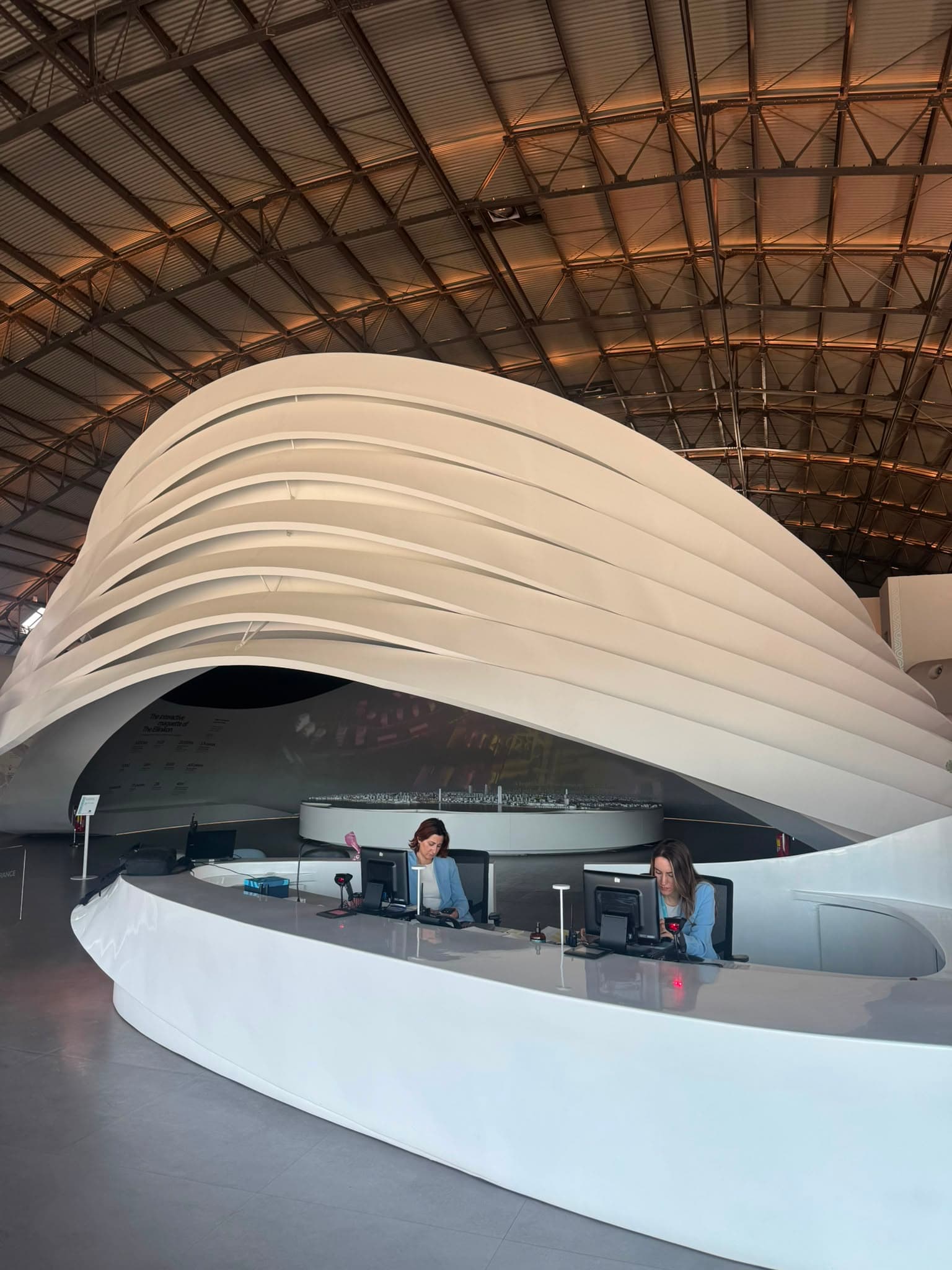 Sculptural white pavilion with the reception desk
