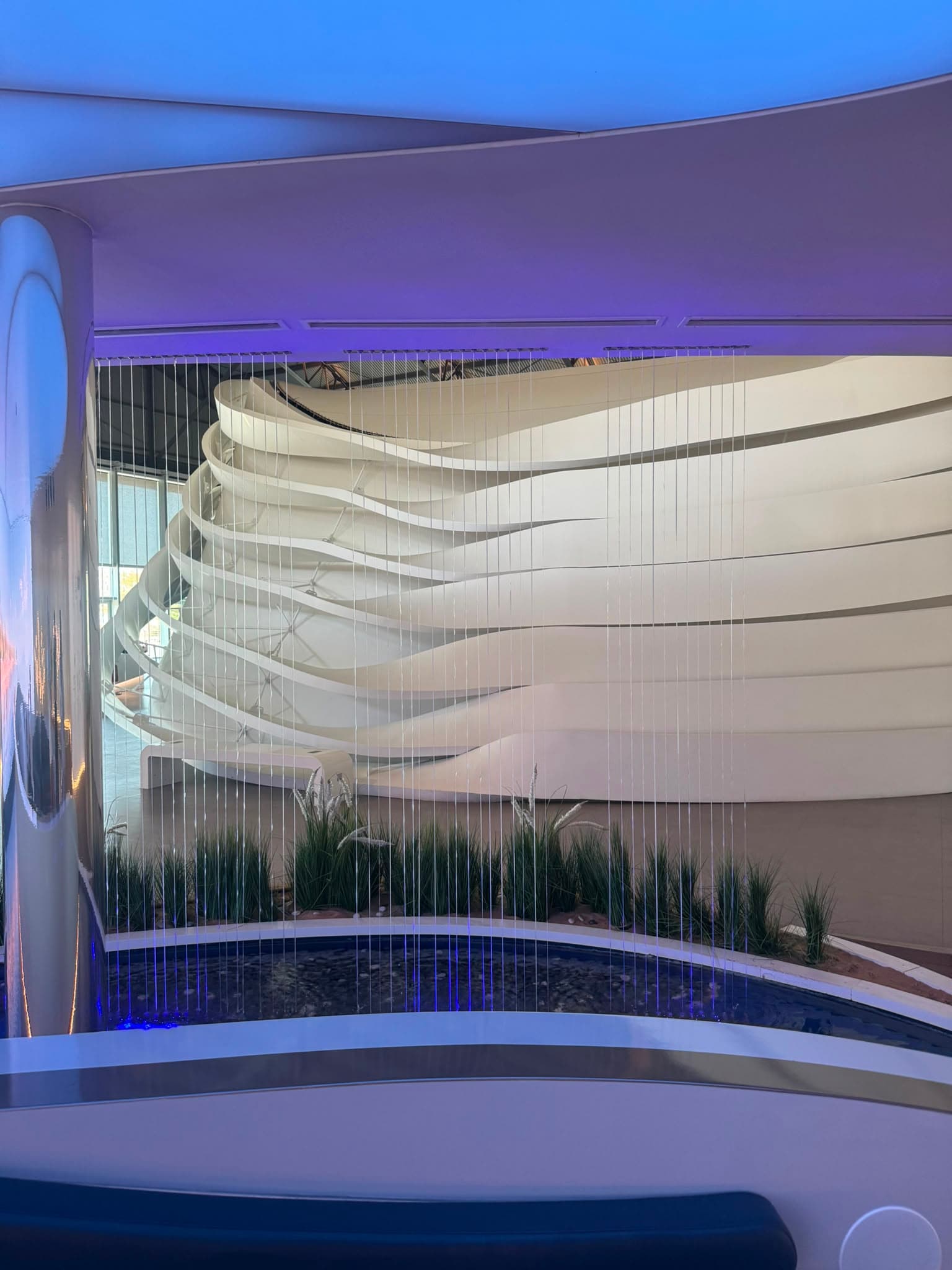Water curtain in front of a sculptural wall